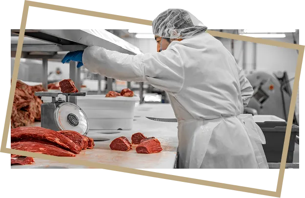 Worker portioning beef cuts